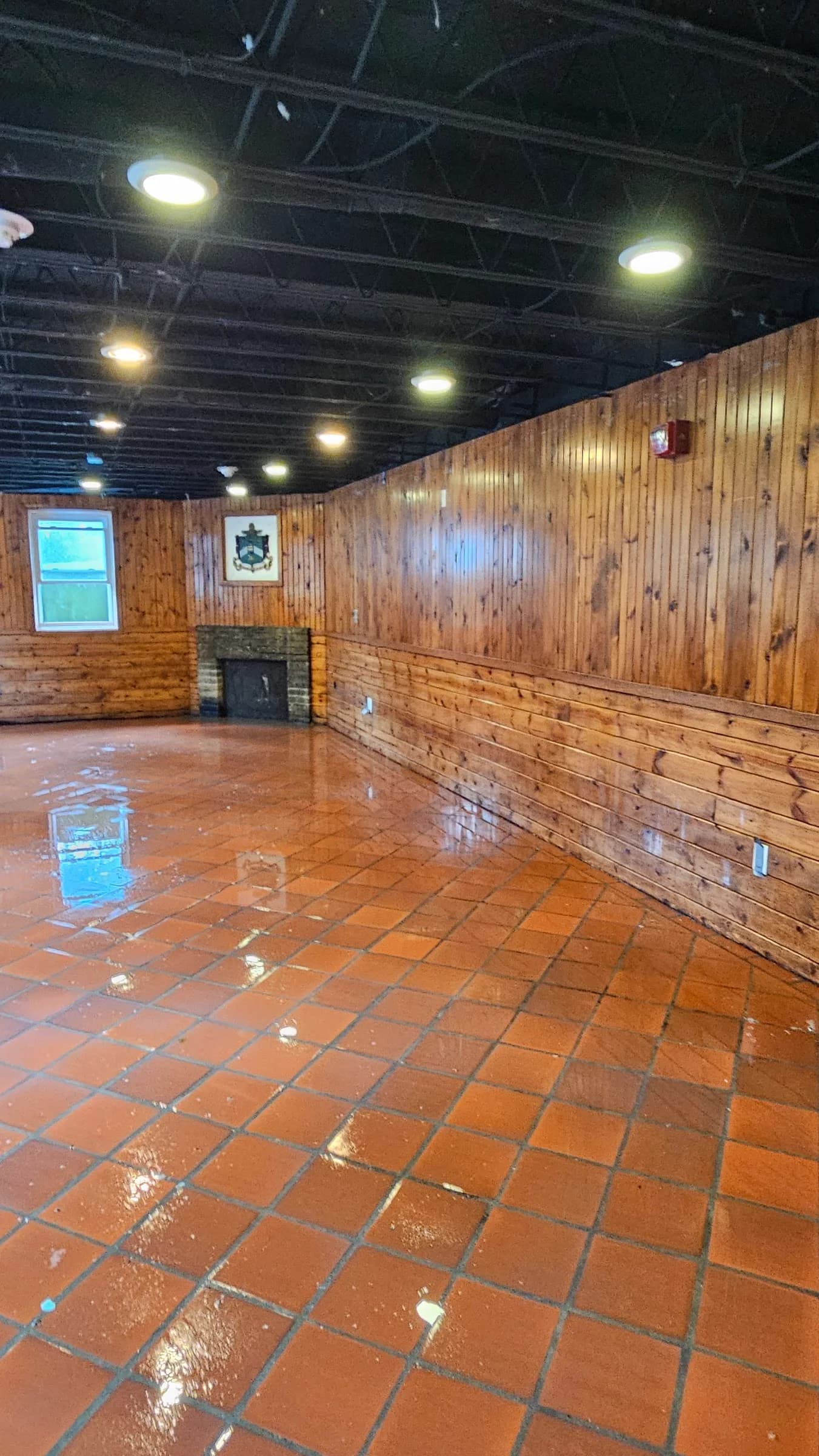 Wood-paneled room with a reflective tile floor from SWAT’s work portfolio
