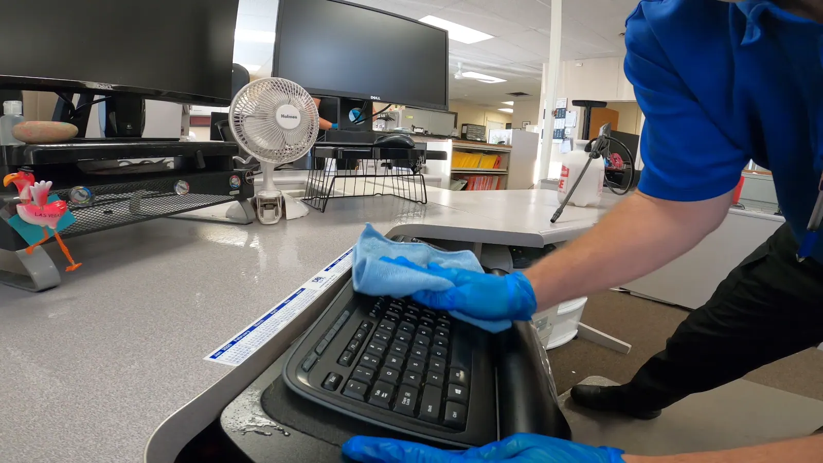 Technician detail-cleaning an office workstation — shared SWAT Network portfolio